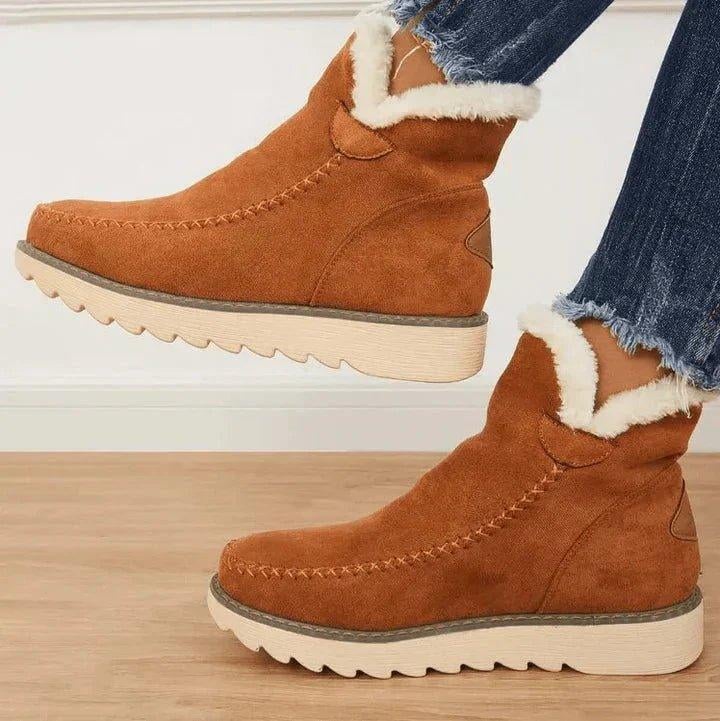 Side profile of PolarBelle winter boots showing water-resistant exterior and non-slip sole in beige