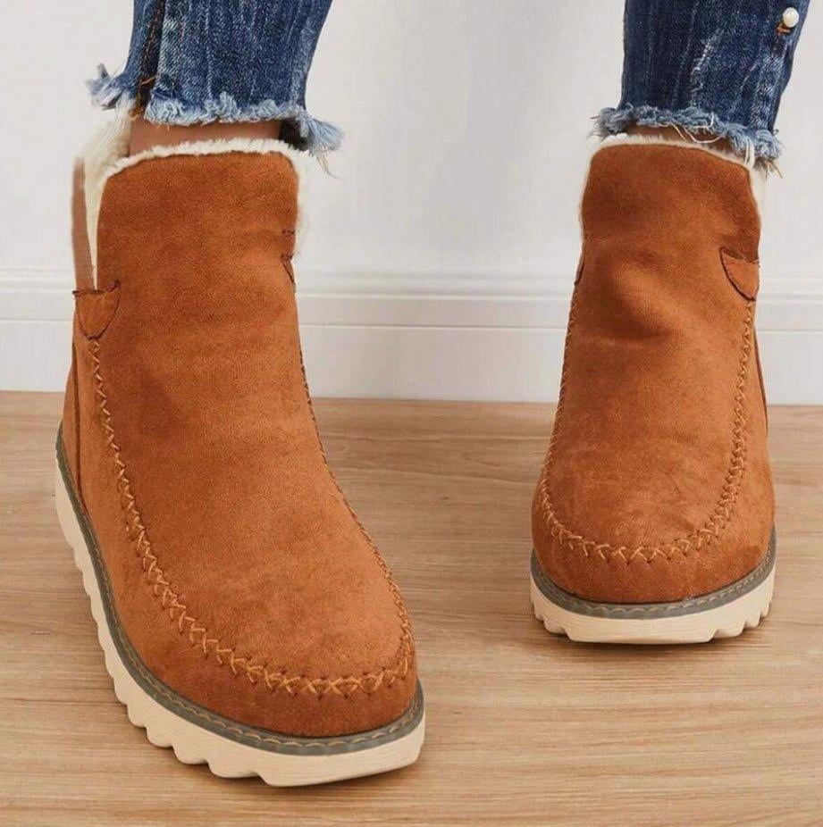 Top-down view of PolarBelle ankle boots showing plush interior lining in black