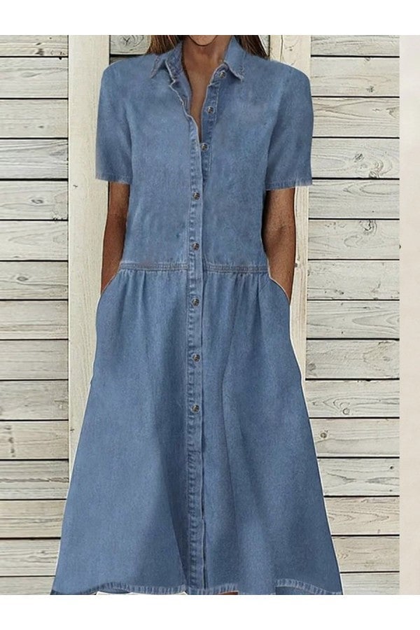 Woman wearing a blue button-down short sleeve midi dress with a collared neckline and side pockets