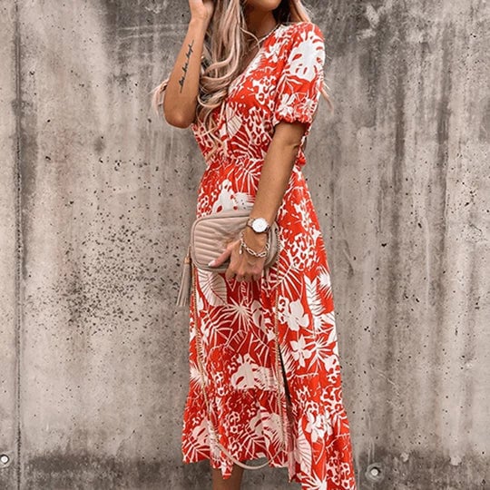 Close-up of the smocked waist and puff short sleeves on the Poppy floral midi dress in red floral print