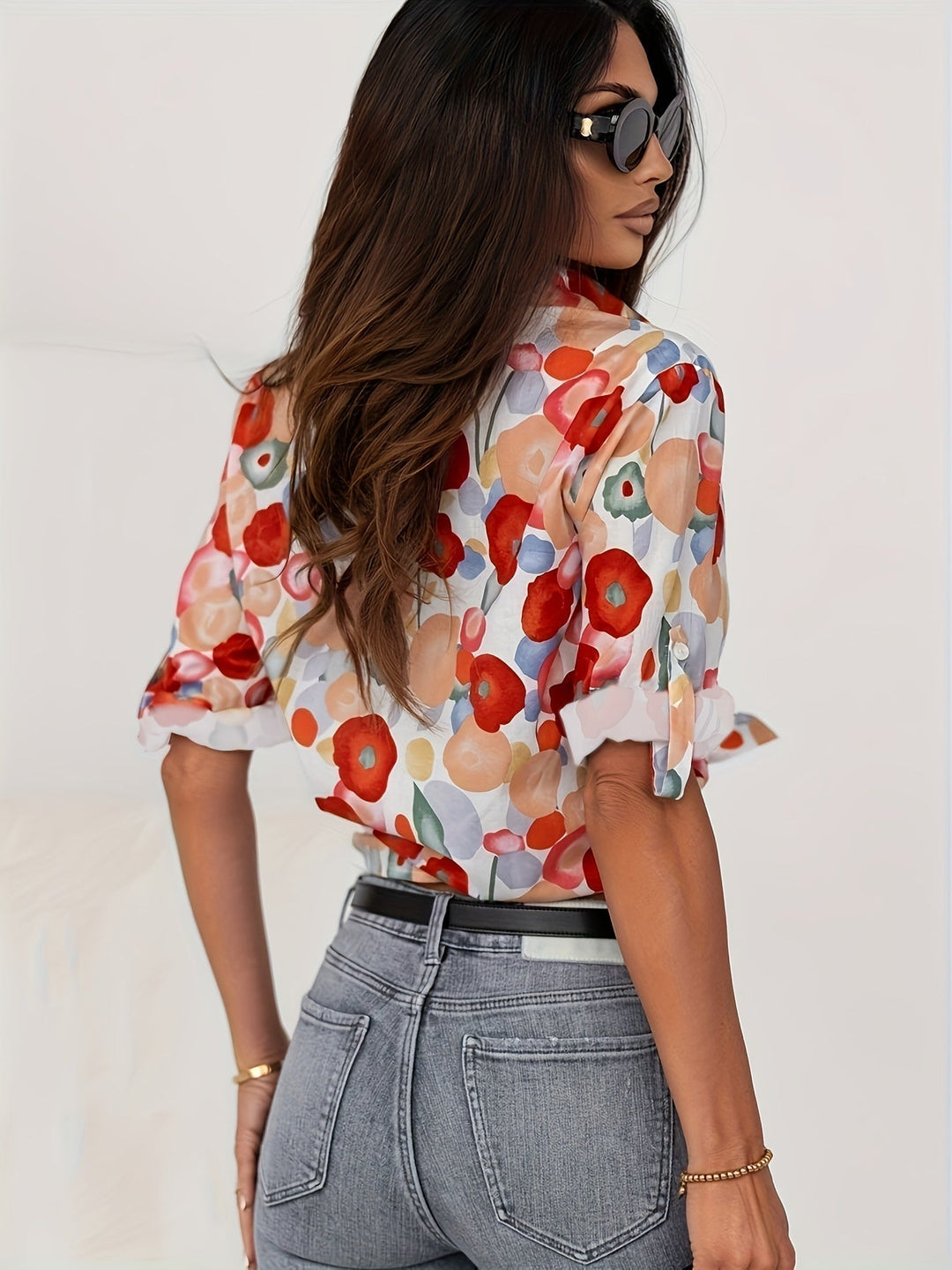 Close-up of the Poppy blouse watercolor floral print and spread collar button-down placket detail