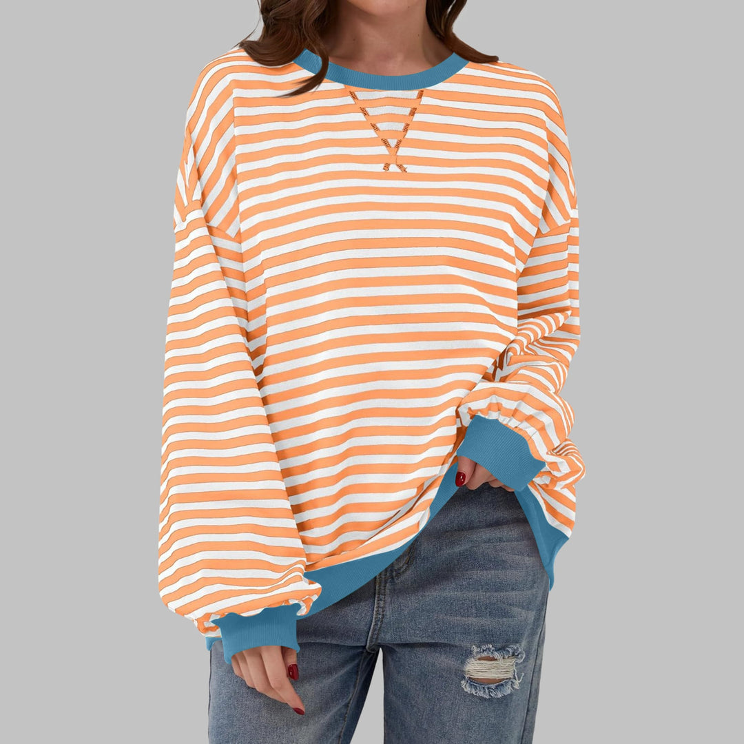Model wearing the Poppy striped sweatshirt with high-waisted jeans and sneakers