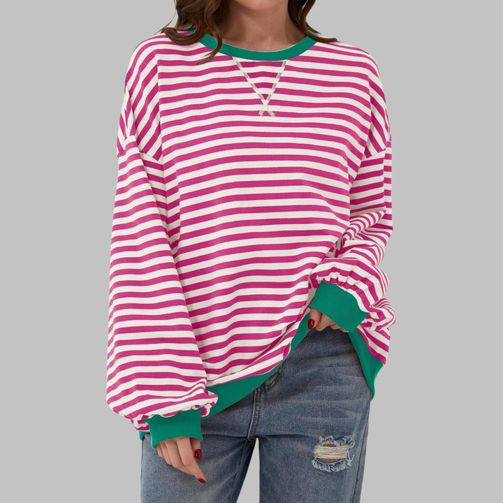 Model wearing the Poppy sweatshirt in Orange colorway with a relaxed casual outfit