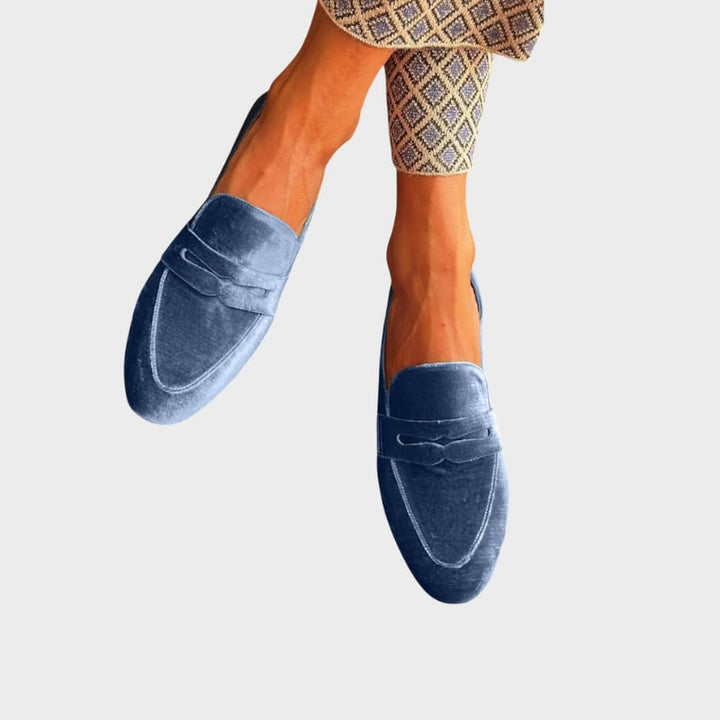 Portia women's blue slip-on loafers shown from a front three-quarter angle on a clean white background