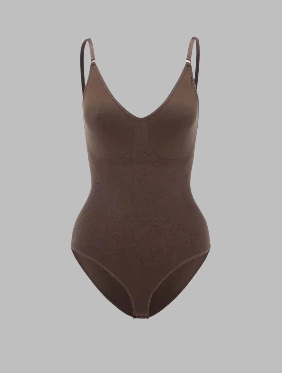 Side profile of model in the PowerSculpt high-waisted bodysuit showing defined waist and smooth stomach