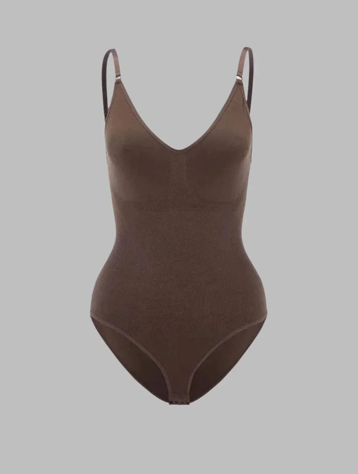 Side profile of model in the PowerSculpt high-waisted bodysuit showing defined waist and smooth stomach