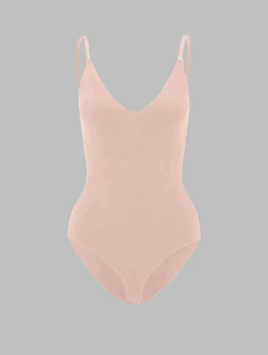 Model wearing the PowerSculpt bodysuit in white under light-colored clothing demonstrating invisible finish