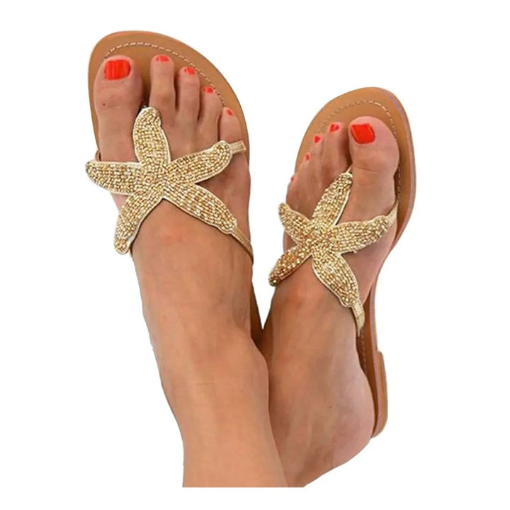 Primrose women's slides in gold showing textured outsole, side view