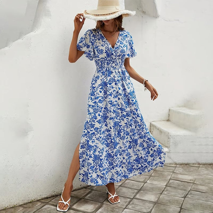 Woman wearing the Primrose blue V-neck boho flowy beach dress in a breezy outdoor setting