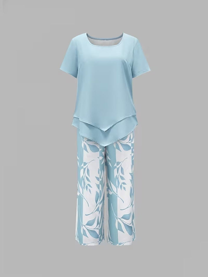 Back view of women's leaf print two piece set in purple, highlighting relaxed fit pants