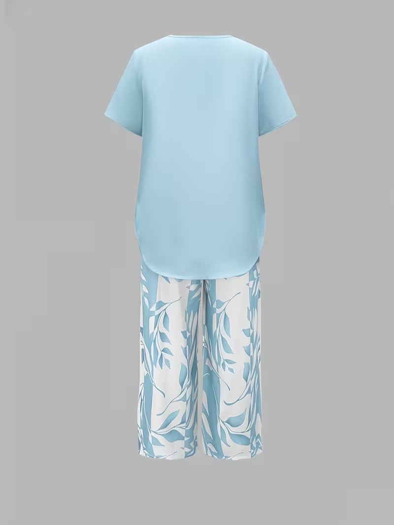 Model styling the red leaf print two piece set with sandals for a casual warm-weather look