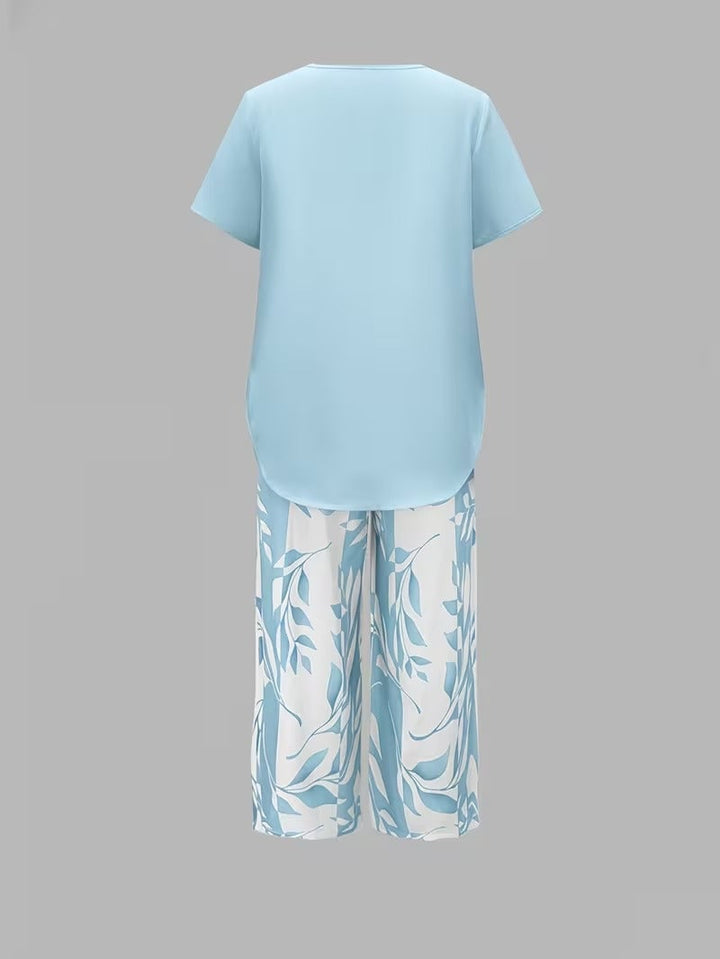 Model styling the red leaf print two piece set with sandals for a casual warm-weather look
