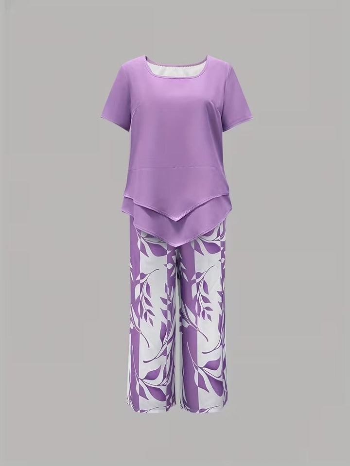 Side view of light blue botanical print two piece set showing short sleeve top and pant length
