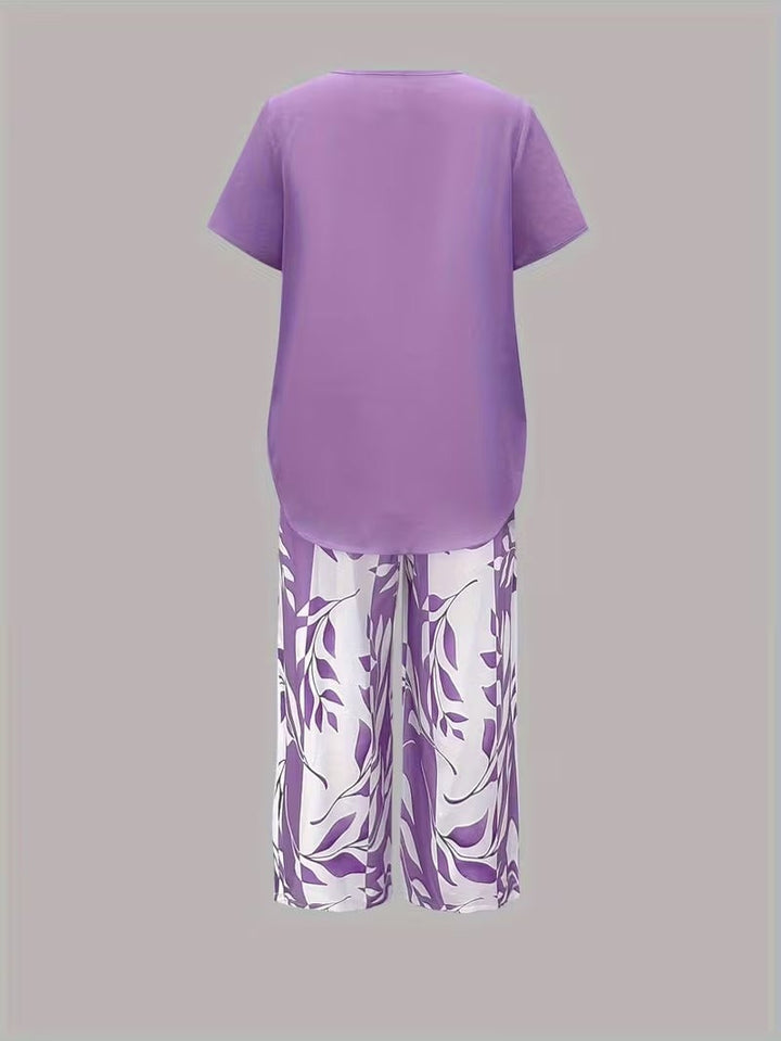 Flat lay of women's leaf print two piece set in green displaying top and pants together