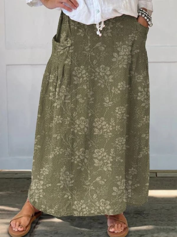 Woman wearing a vintage floral A-line skirt with elastic waistband in a green floral print, styled with a white blouse