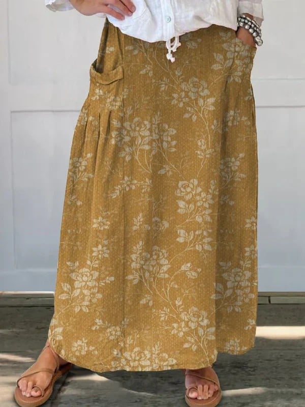 Close-up of the vintage floral skirt's side pocket and flowing fabric detail in yellow floral print