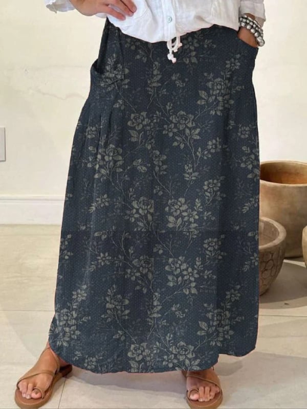 Full-length view of the vintage floral A-line skirt in navy blue, showing the smooth silhouette and midi length