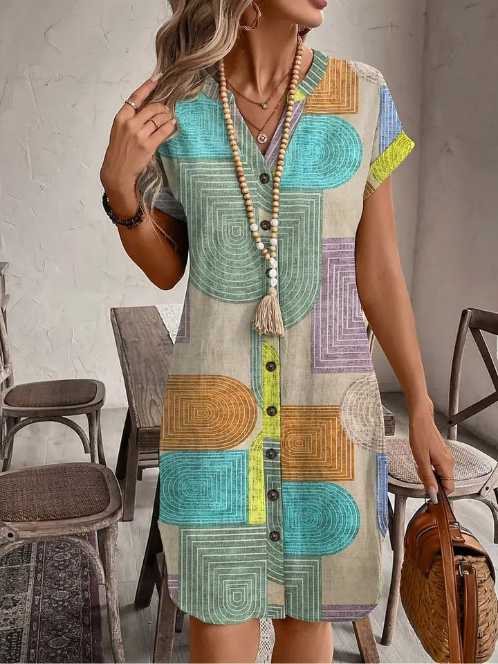 Front view of the Prism geometric print mini dress in multicolor teal, terracotta, lavender, and yellow with a button-front V-neckline