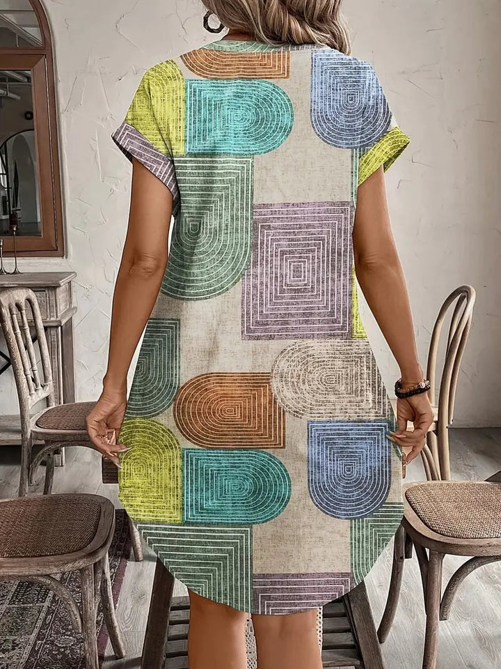 Side view of the Prism geometric print mini dress showing the cap sleeve and above-the-knee hem