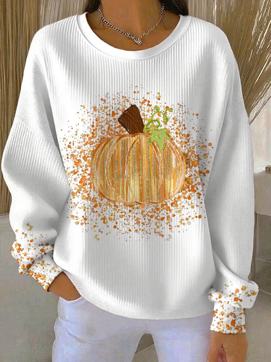 Close-up of pumpkin artwork detail on a cozy fall sweatshirt available in black, white, orange, and light gray