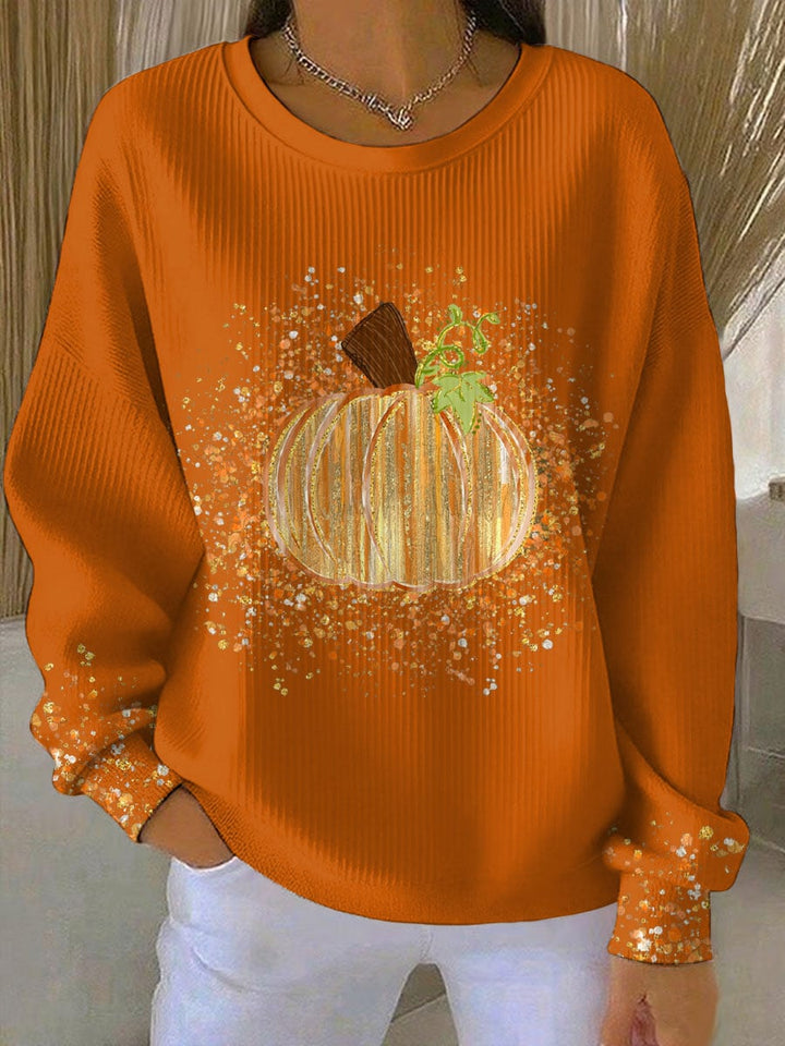 Model wearing a light gray pumpkin graphic sweatshirt styled with jeans for a casual autumn look