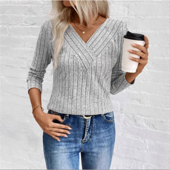 Side view of the Florimay sunken stripe sweater showing its graceful drape and relaxed silhouette