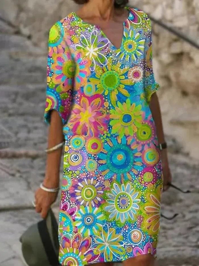 Front view of the Quinn floral dress in pink, highlighting feminine neckline detailing and flowing hem