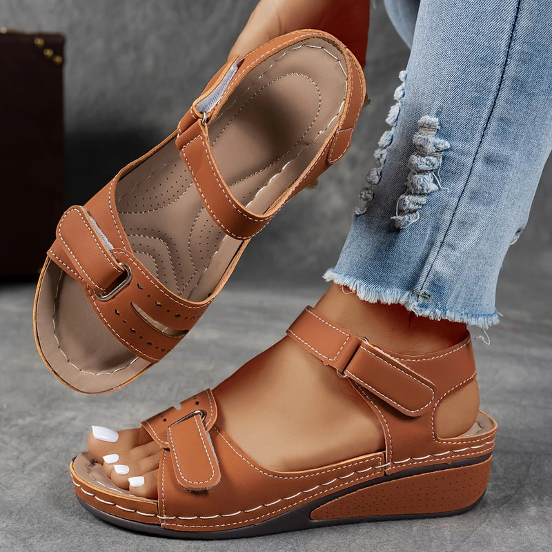 Rae women's platform cushioned wedge sandal in black, back view showing adjustable strap