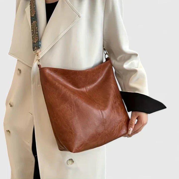 Close-up of the artistic patterned shoulder strap on the Ragnelle shoulder bag