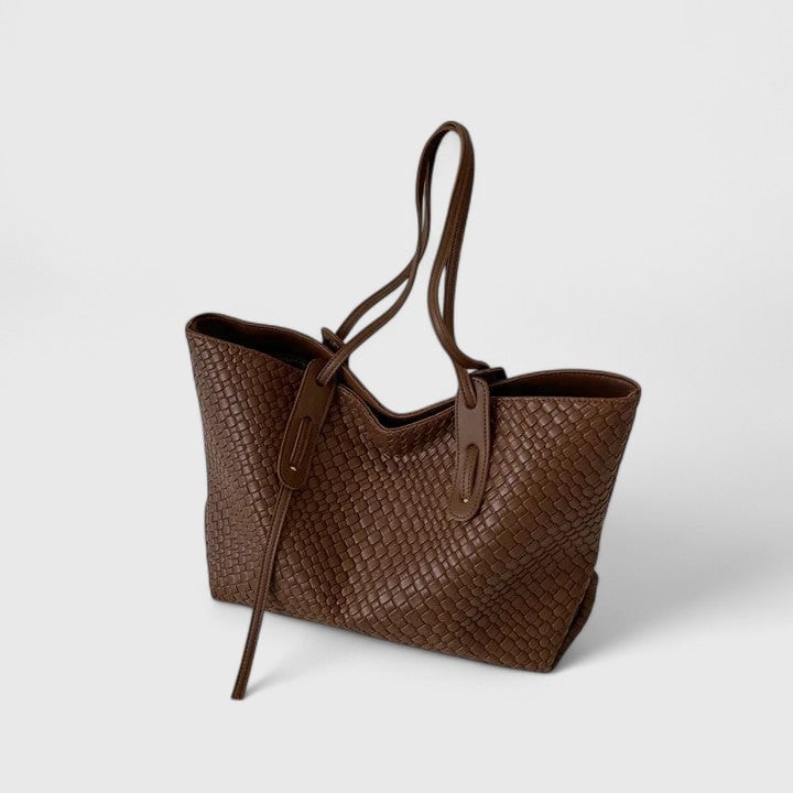 Classic woven tote bag in black with long shoulder straps on a clean background