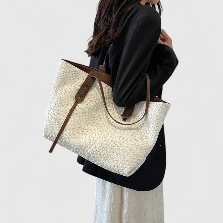 Khaki woven tote bag styled flat lay with neutral accessories