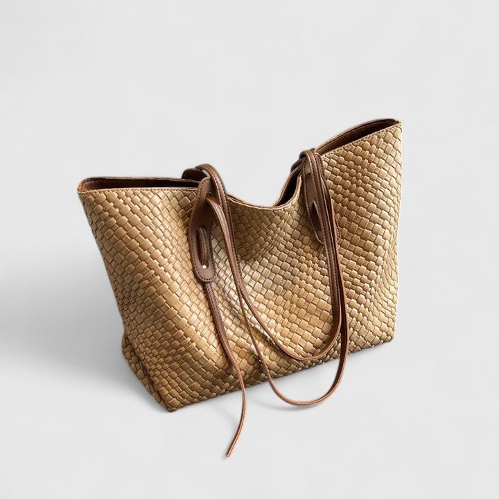 Woven tote bag in khaki resting against a minimal light background