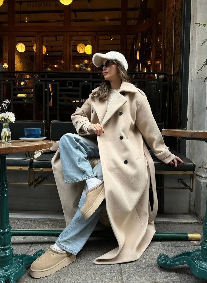 Model wearing the Ramona coat in Light Khaki paired with trousers for a chic workwear outfit