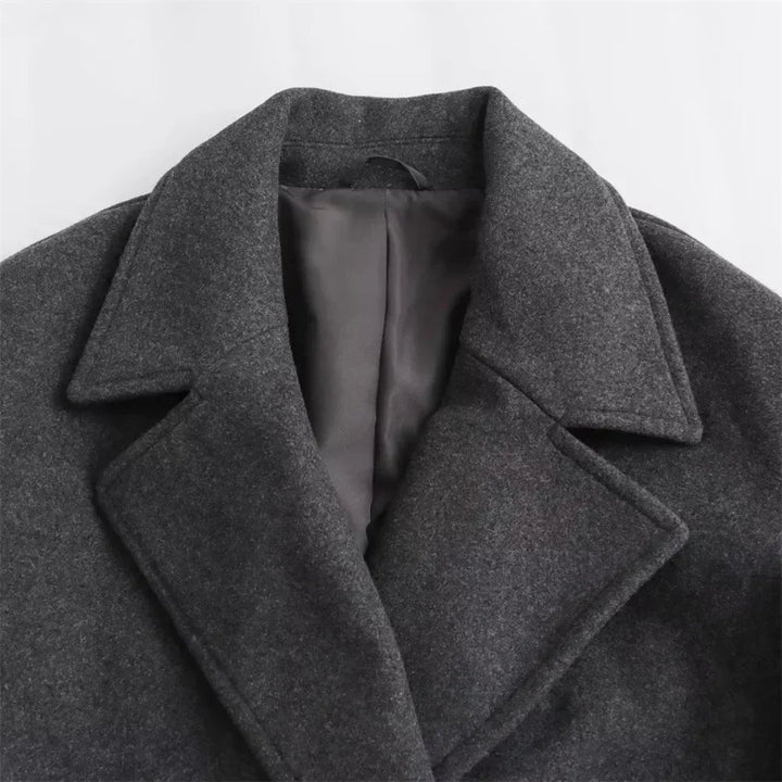 Close-up of the Ramona coat hem and sleeve cuffs showing polished finishing details
