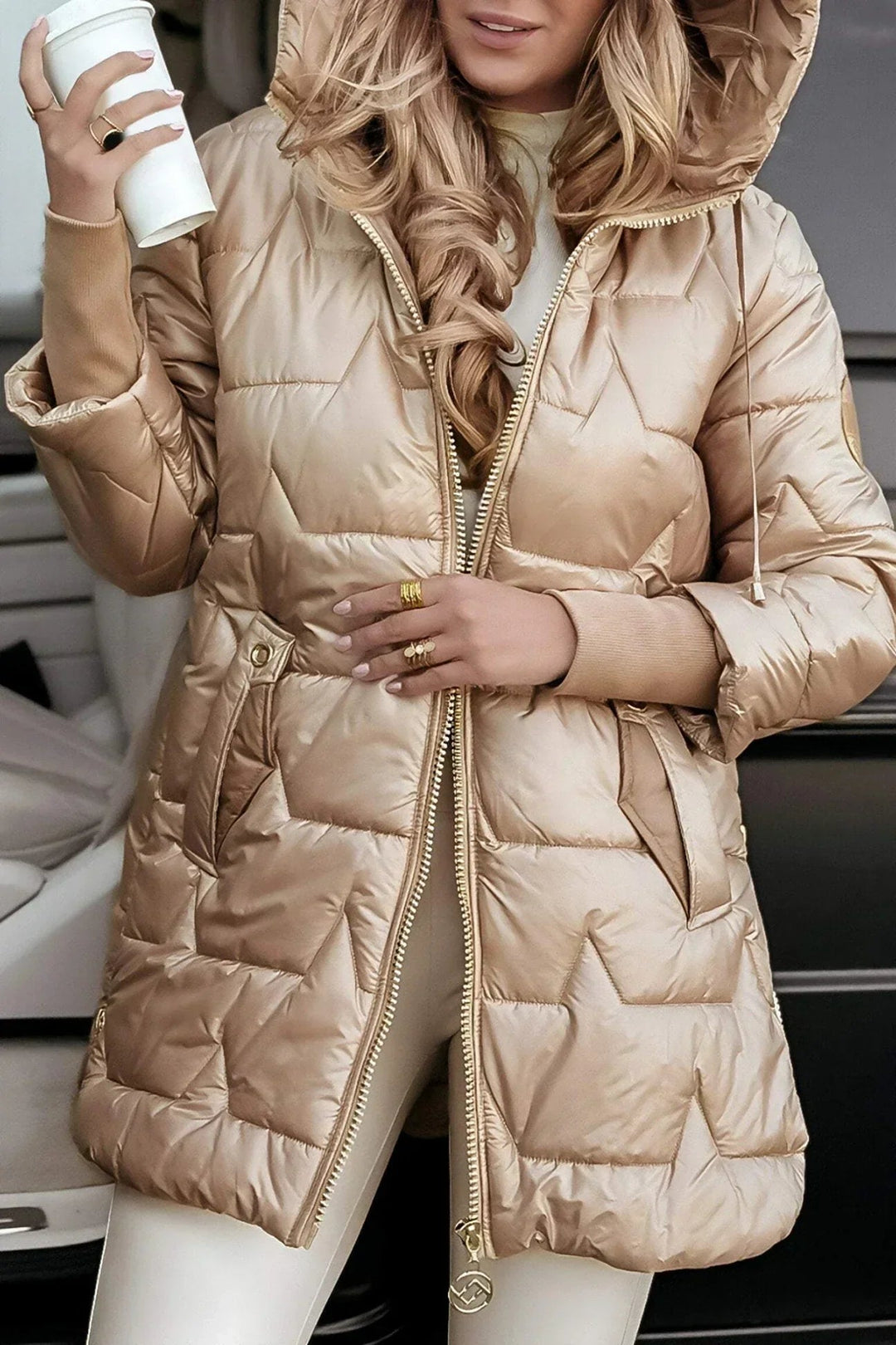 Woman wearing a tailored beige winter coat with a sleek silhouette against a neutral background