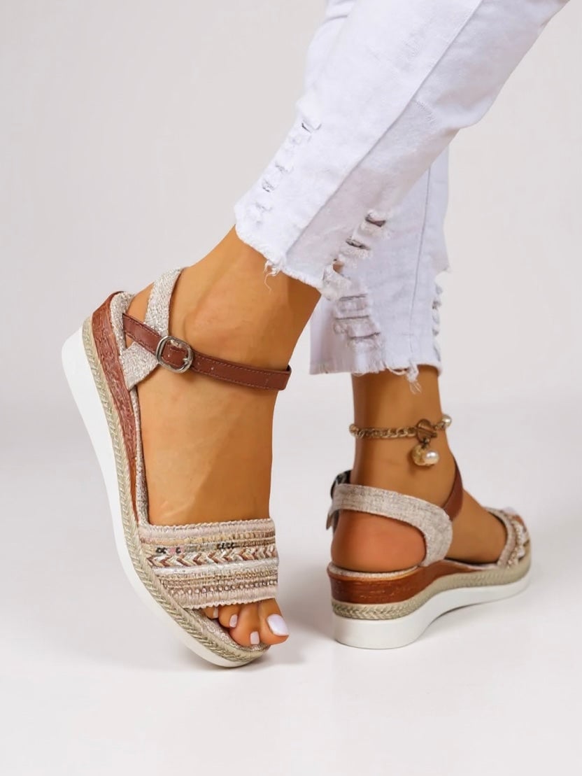 Raven beaded wedge sandals shown from the front, featuring shimmering bead embellishments and a cushioned wedge sole