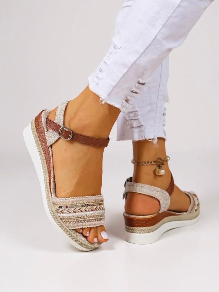 Raven beaded wedge sandals shown from the front, featuring shimmering bead embellishments and a cushioned wedge sole
