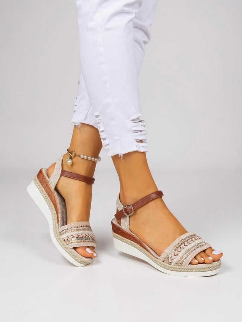 Close-up of the intricate beaded detailing on the Raven wedge sandals straps