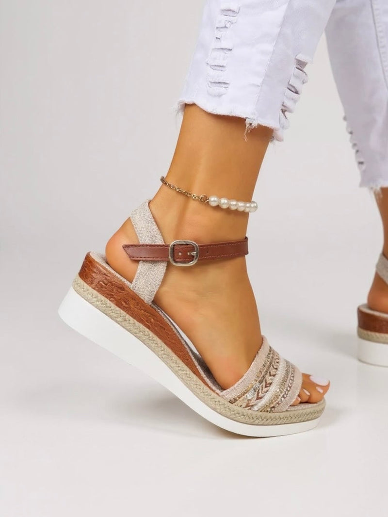 Raven beaded wedge sandals styled on feet, showing full silhouette and heel height
