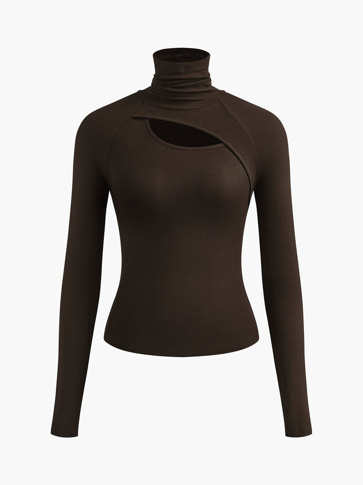Woman wearing the Ravena white turtleneck cutout top tucked into high-waist pants, front view
