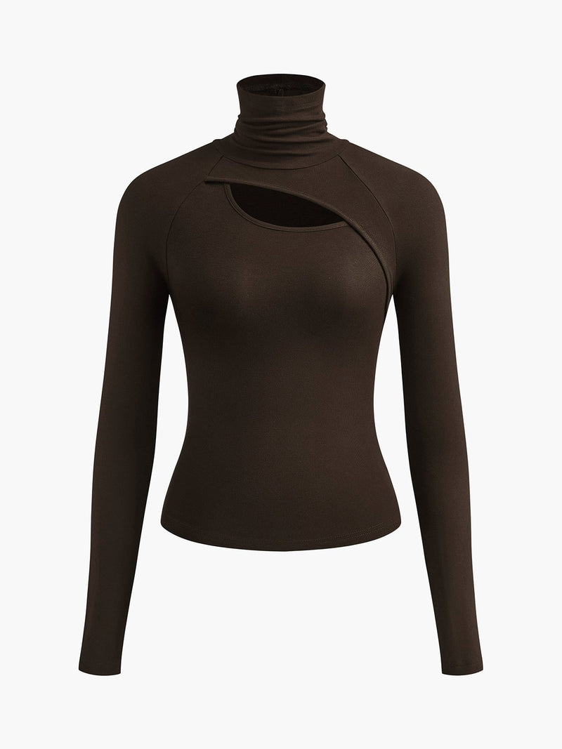 Woman wearing the Ravena white turtleneck cutout top tucked into high-waist pants, front view
