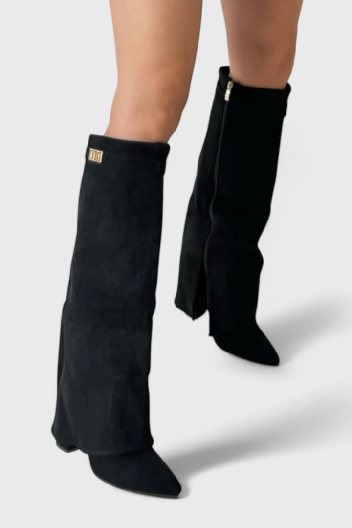 Raya black suede boots styled with skinny jeans, close-up from knee down