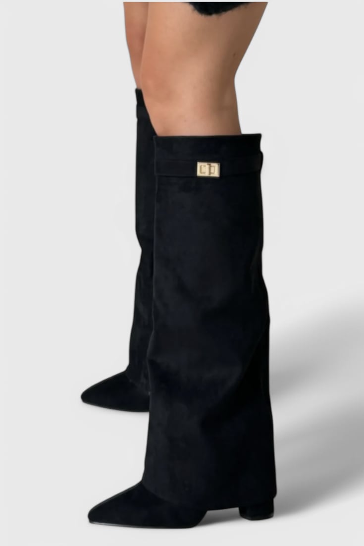 Raya black faux leather boots on a model, side view showing leg-lengthening silhouette