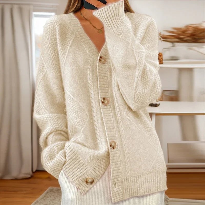 Woman wearing a beige cable knit cardigan with a relaxed fit, styled over a casual outfit