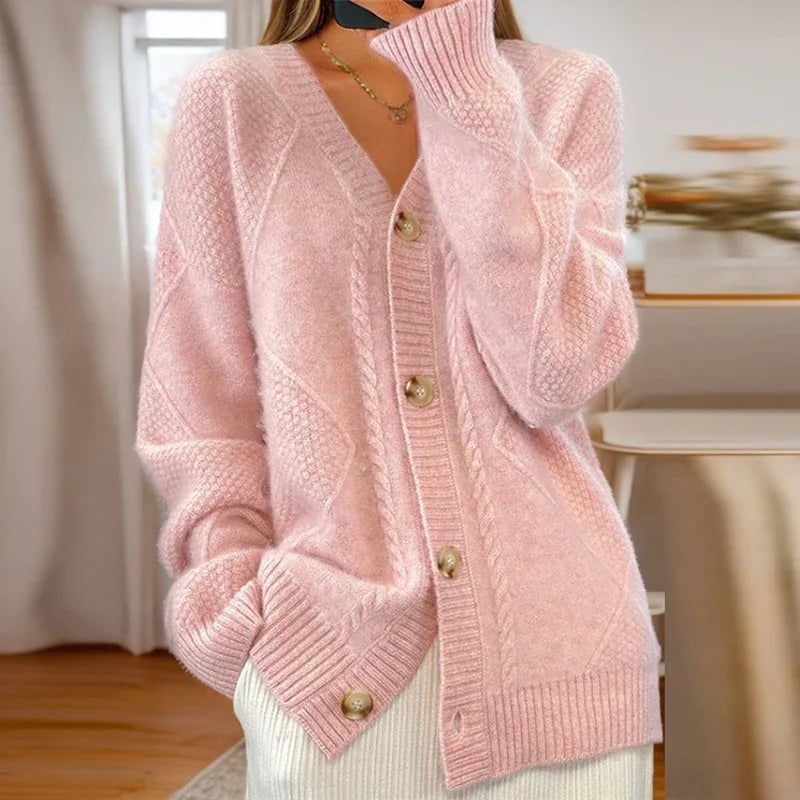 Close-up of the classic cable knit texture on the Reagan cardigan in a neutral color