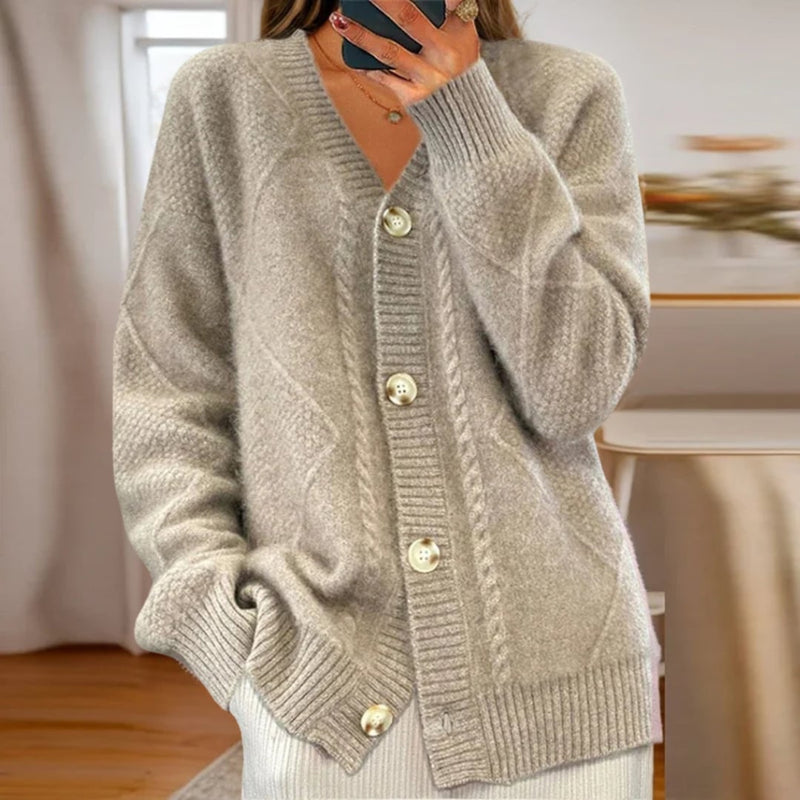 Full-length view of the Reagan cardigan in gray paired with jeans and ankle boots