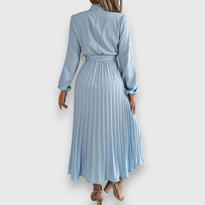 Front view of elegant pleated midi dress in pink showing flattering silhouette
