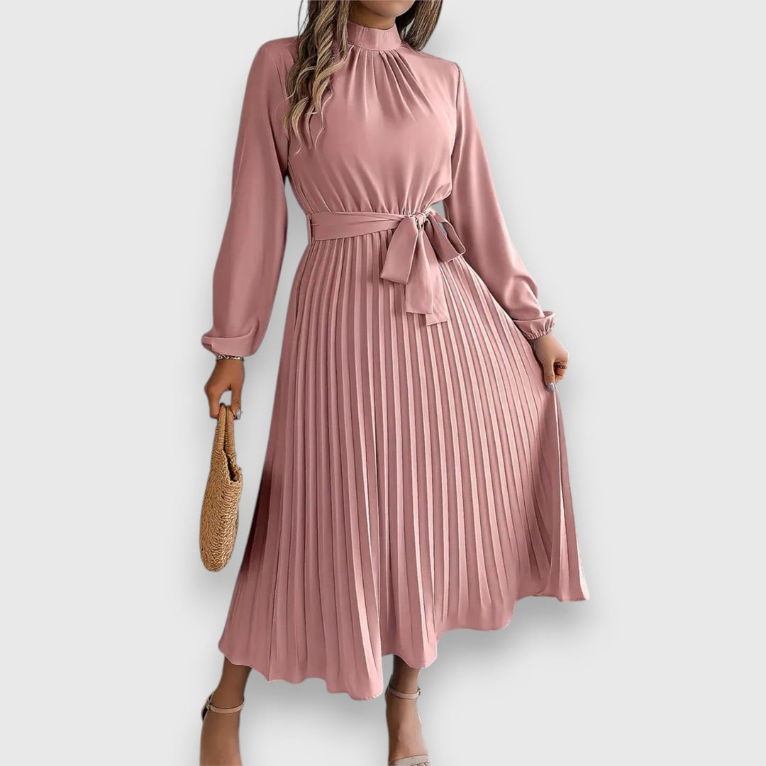 Close-up of graceful pleated fabric detail on a midi dress in beige
