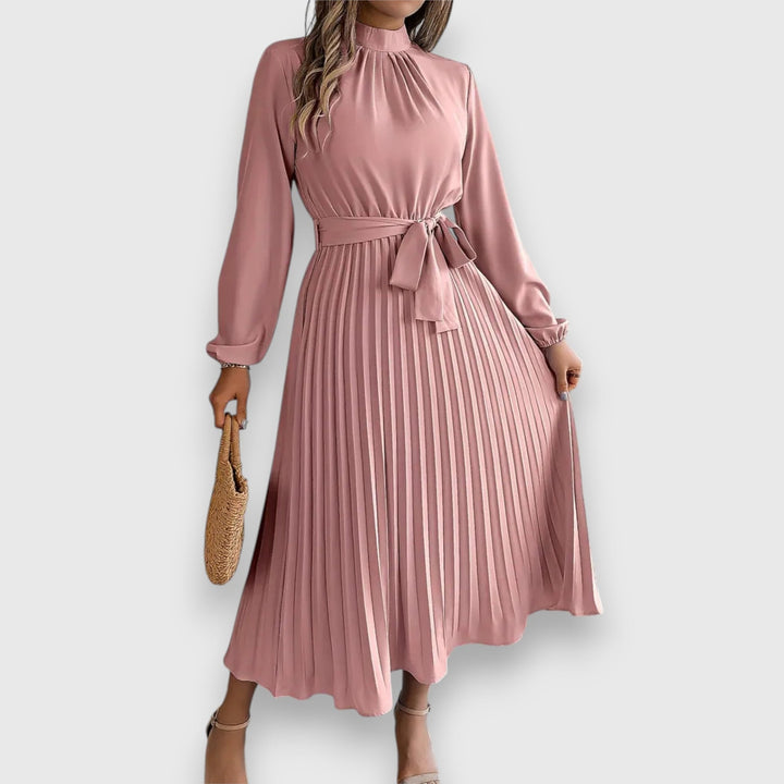 Close-up of graceful pleated fabric detail on a midi dress in beige