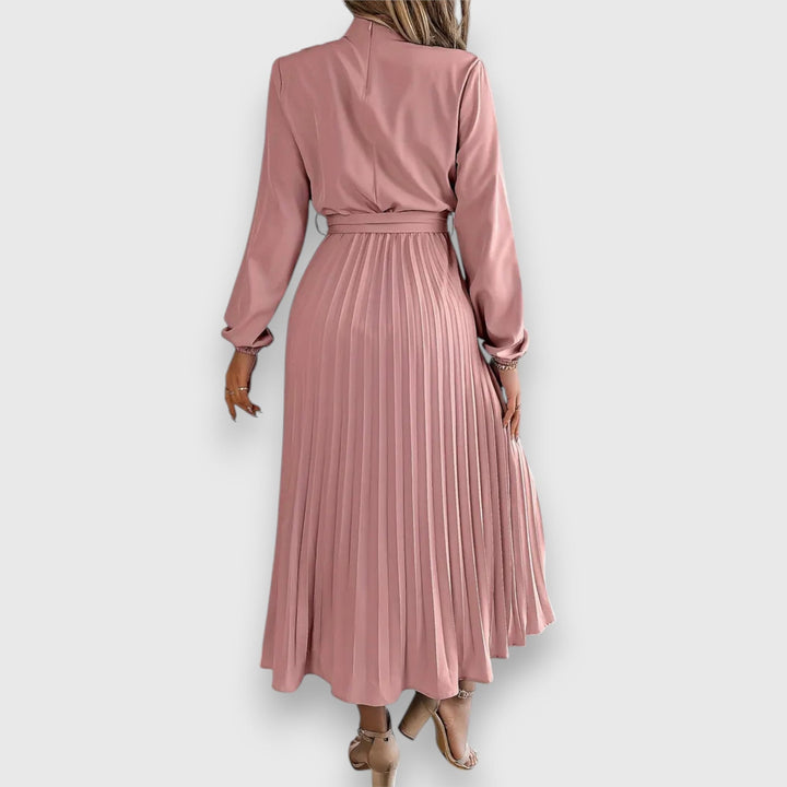 Model in red elegant pleated midi dress styled with heels for a formal occasion